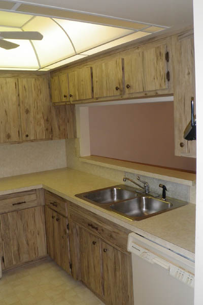 wood style cabinets with a silver sink