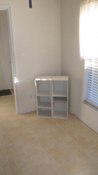 white wall with a cabinet in the corner